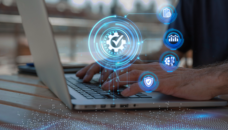Hands on laptop keyboard with digital IT management icons representing technology oversight and performance.