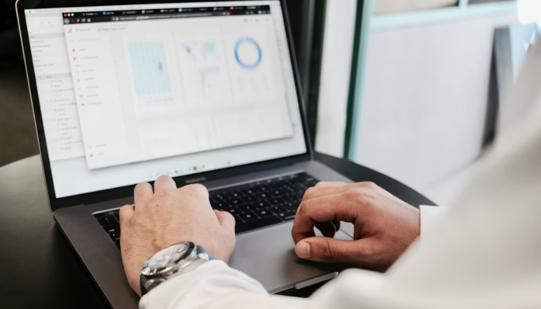 IT team using SharePoint on computer screens for collaboration.